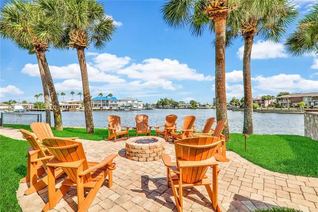 a view of a lake with couches chairs