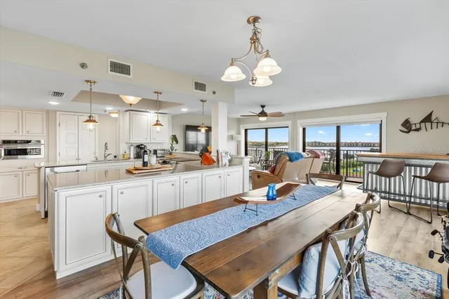 a large kitchen with a table and chairs