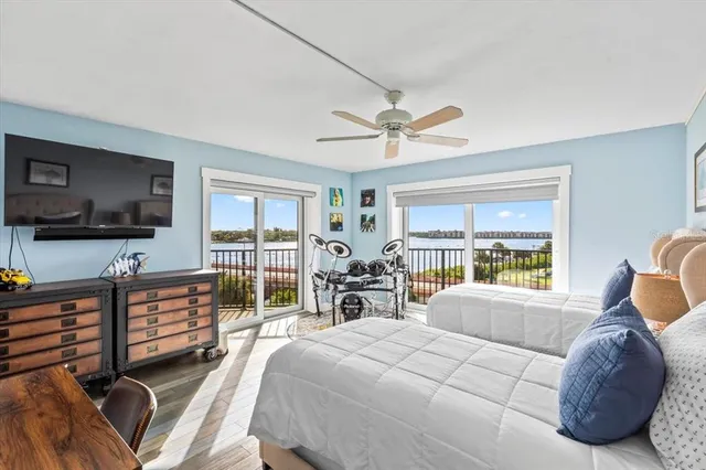 a bedroom with a large bed and a large window