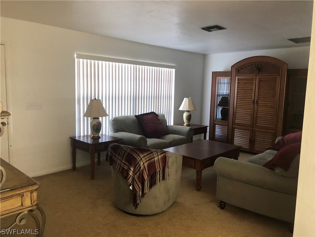 358 Delaware Road Lehigh Acres, FL 33936 - Photo 6 of 22 a living room with furniture and a window