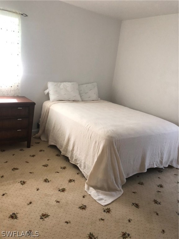 358 Delaware Road Lehigh Acres, FL 33936 - Photo 9 of 22 a bedroom with a bed and a window