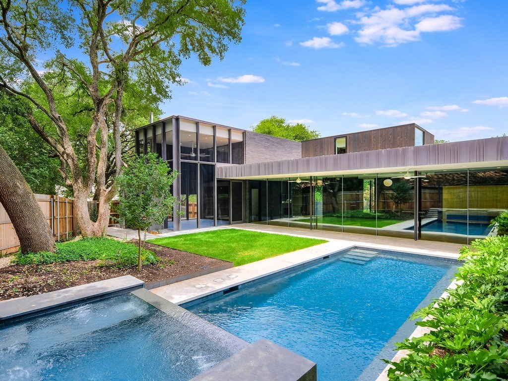 a view of pool with a garden and plants