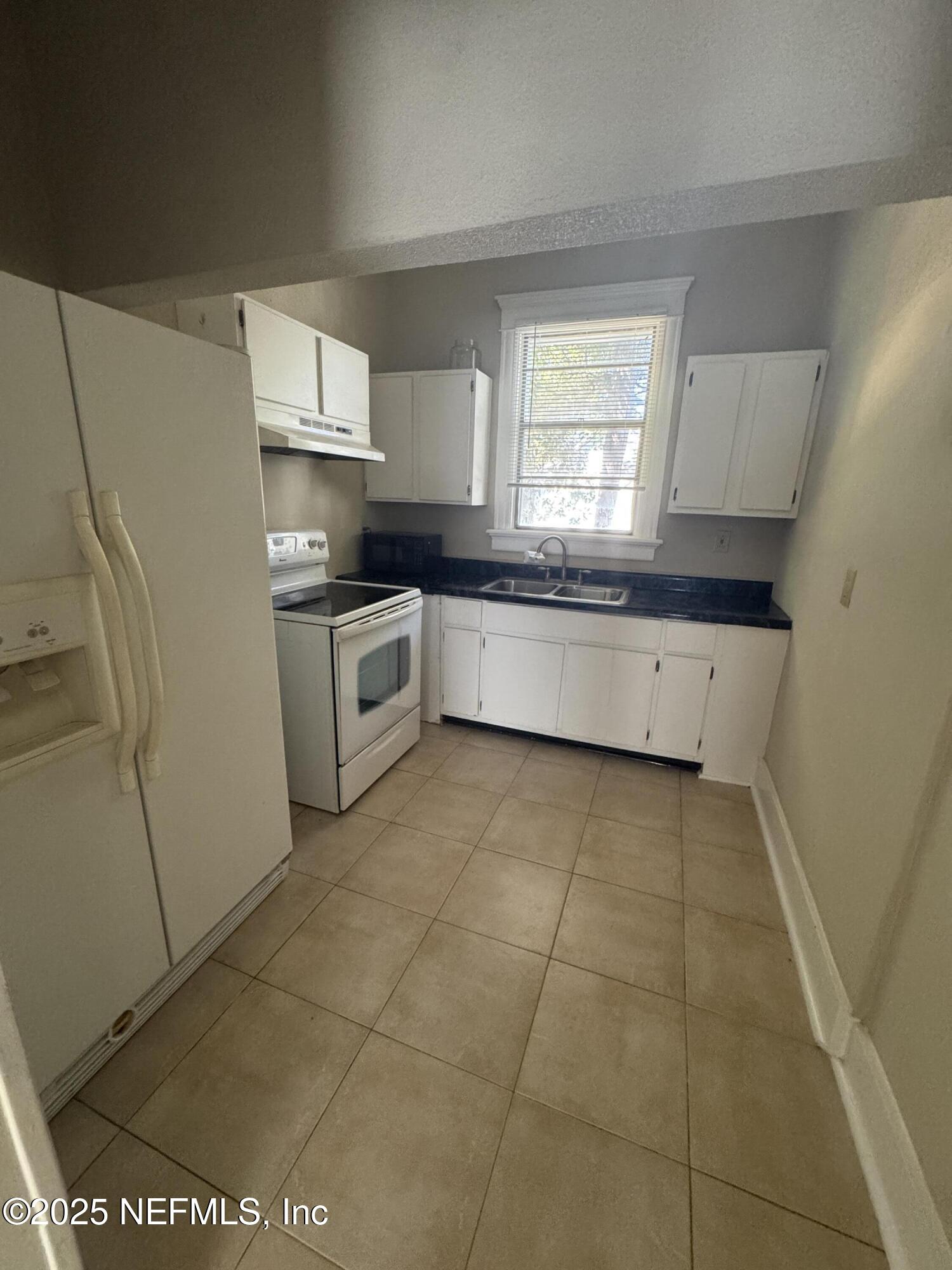 1604 Cherry Street, Unit 4 Jacksonville, FL 32205 - Photo 6 of 11 a kitchen with a stove a sink and a refrigerator