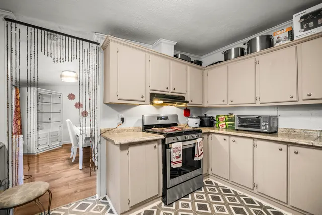 a kitchen with stainless steel appliances granite countertop a stove a sink and a refrigerator