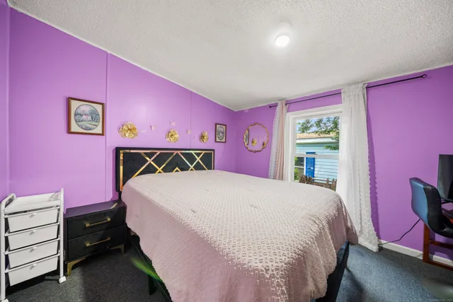 a bed room with a bed and a dresser