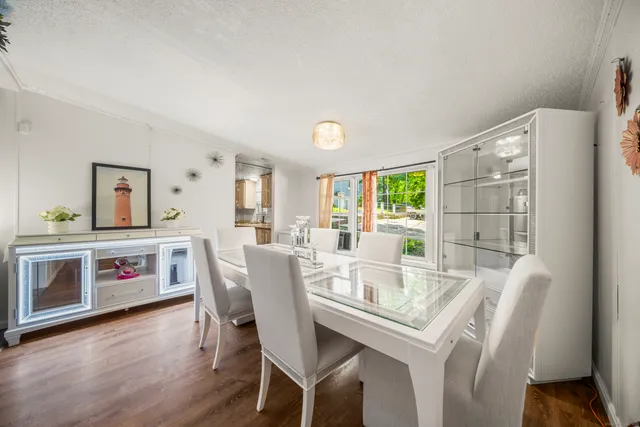 a dining room with furniture and wooden floor