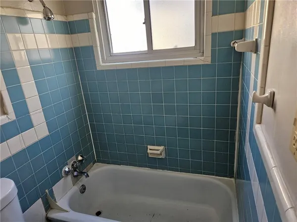 a view of a room with wooden floor and a window