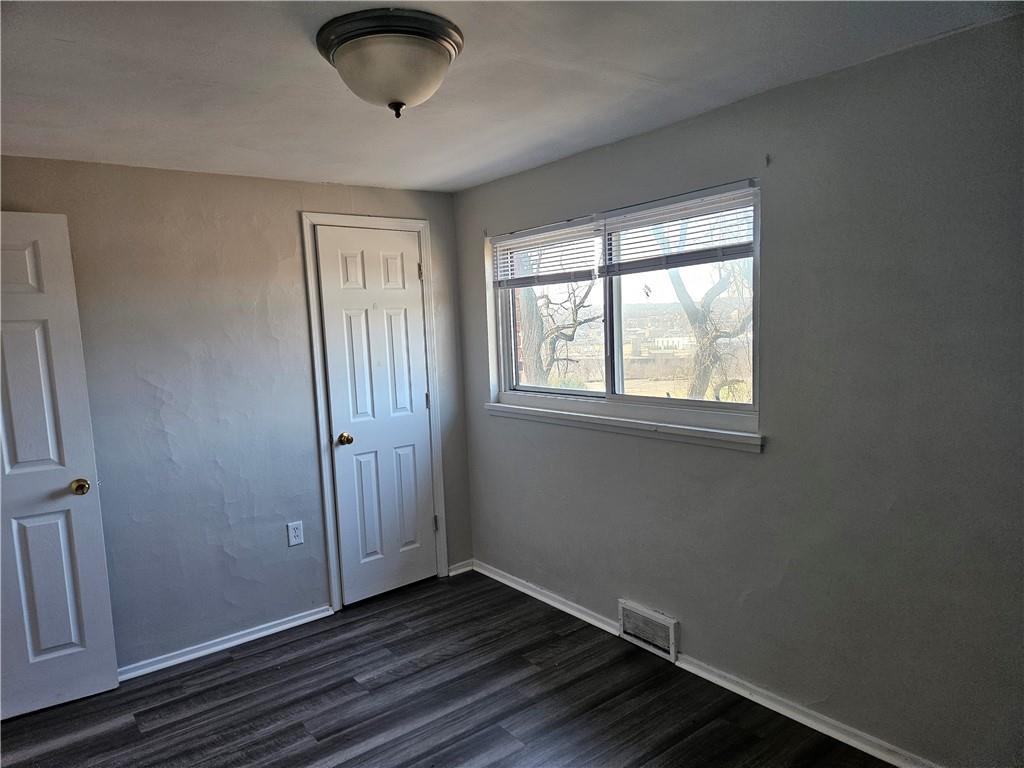 1907 Hanover Street, Unit 8 Swissvale, PA 15218 - Photo 15 of 23 an empty room with wooden floor and windows