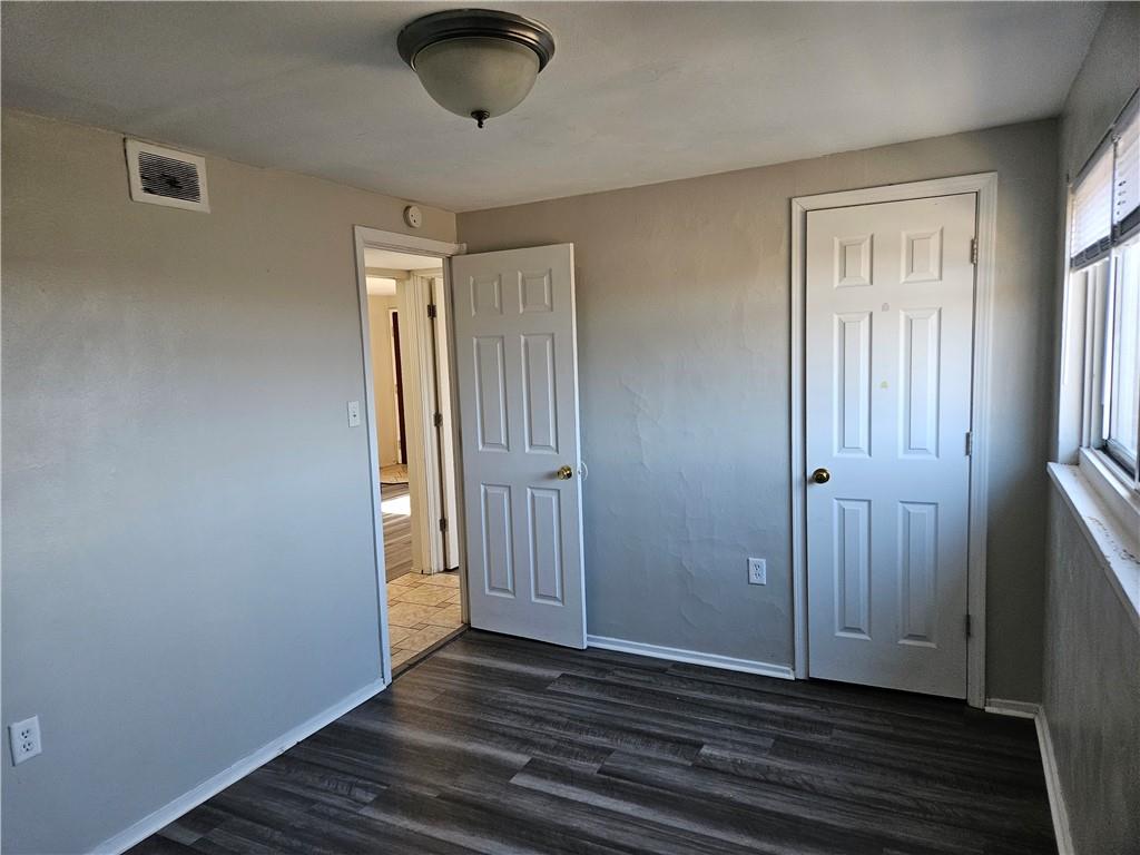 1907 Hanover Street, Unit 8 Swissvale, PA 15218 - Photo 17 of 23 an empty room with wooden floor and windows