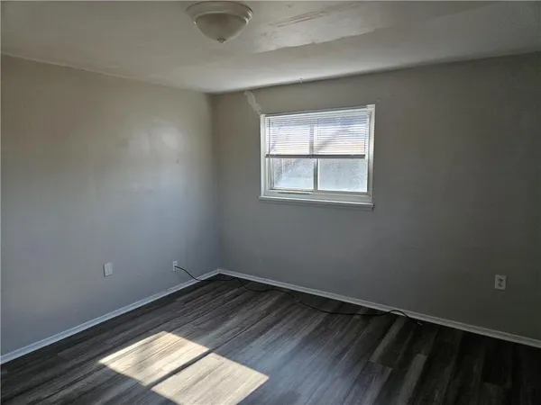 a view of an empty room and wooden floor