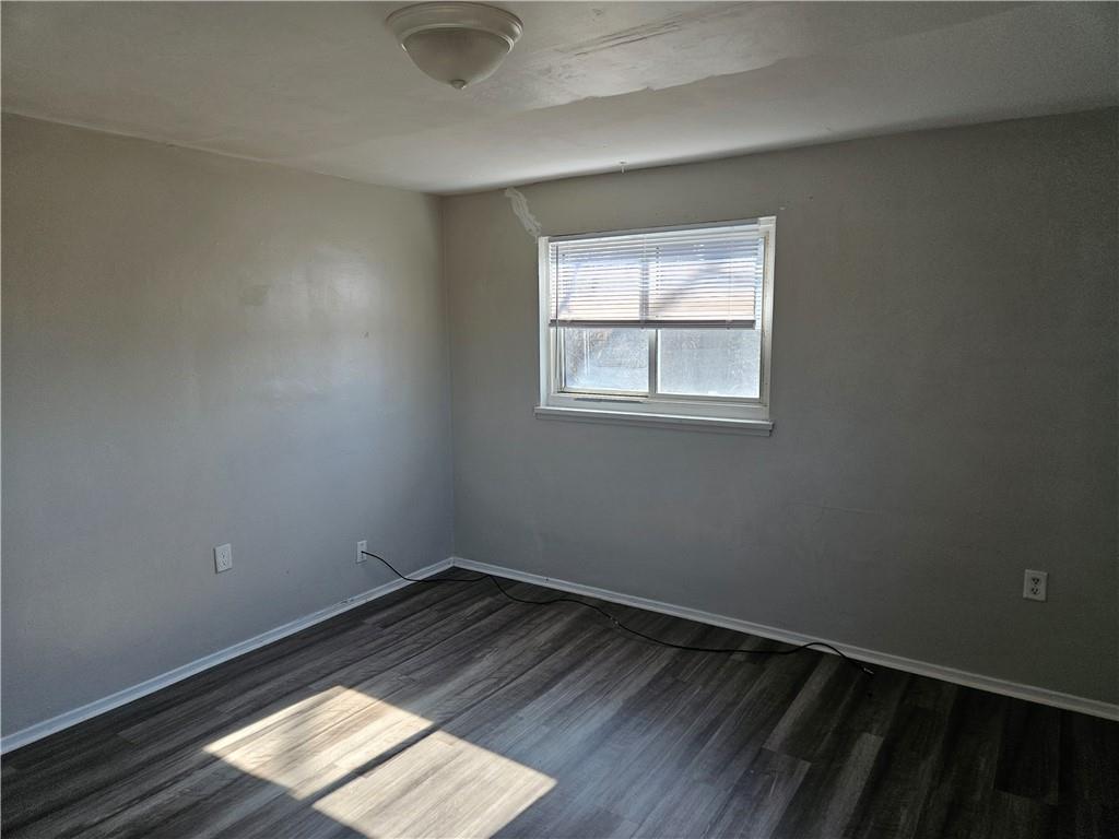 1907 Hanover Street, Unit 8 Swissvale, PA 15218 - Photo 19 of 23 an empty room with wooden floor and windows