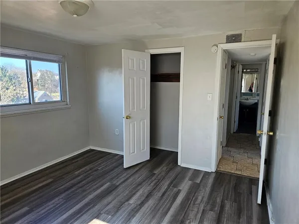 a view of a room with wooden floor and window