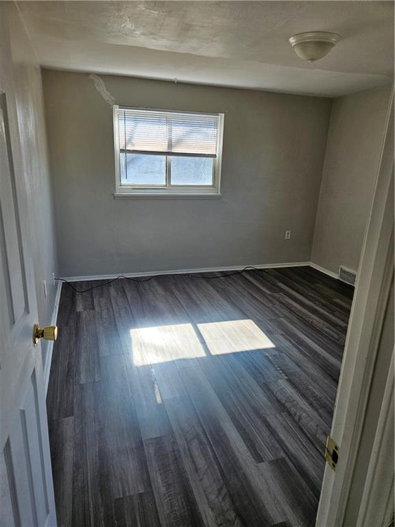 1907 Hanover Street, Unit 8 Swissvale, PA 15218 - Photo 23 of 23 an empty room with wooden floor and windows