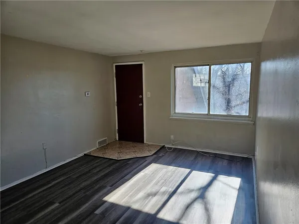 a view of an empty room and wooden floor
