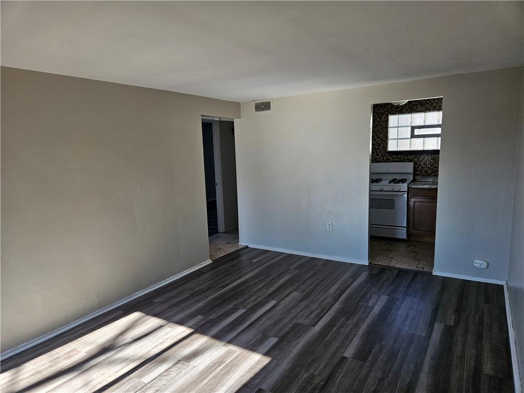 1907 Hanover Street, Unit 8 Swissvale, PA 15218 - Photo 4 of 23 a view of an empty room with wooden floor and a window