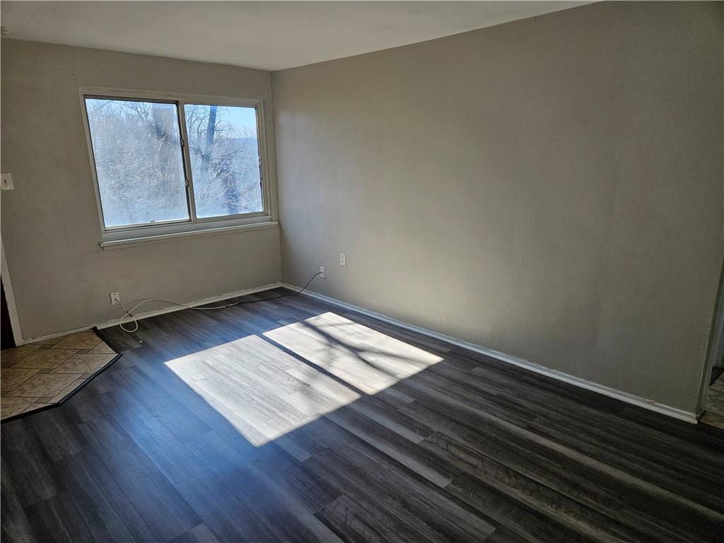 1907 Hanover Street, Unit 8 Swissvale, PA 15218 - Photo 5 of 23 an empty room with wooden floor and windows