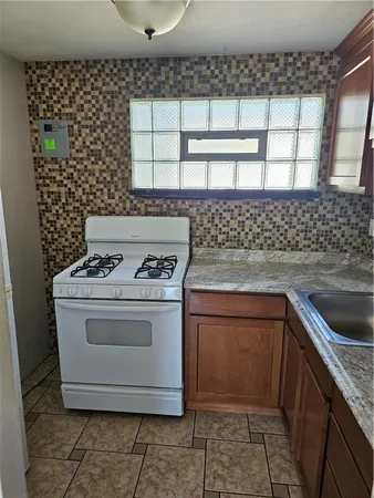 a stove top oven sitting inside of a kitchen