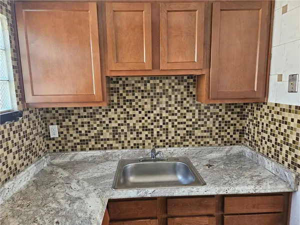 a bathroom with a sink and a granite countertop