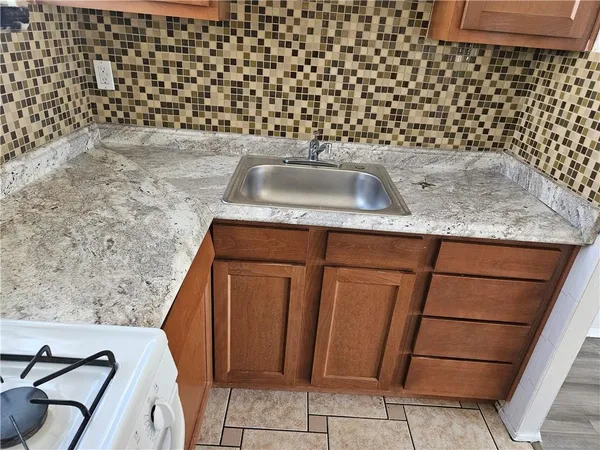 a kitchen with a sink and cabinets