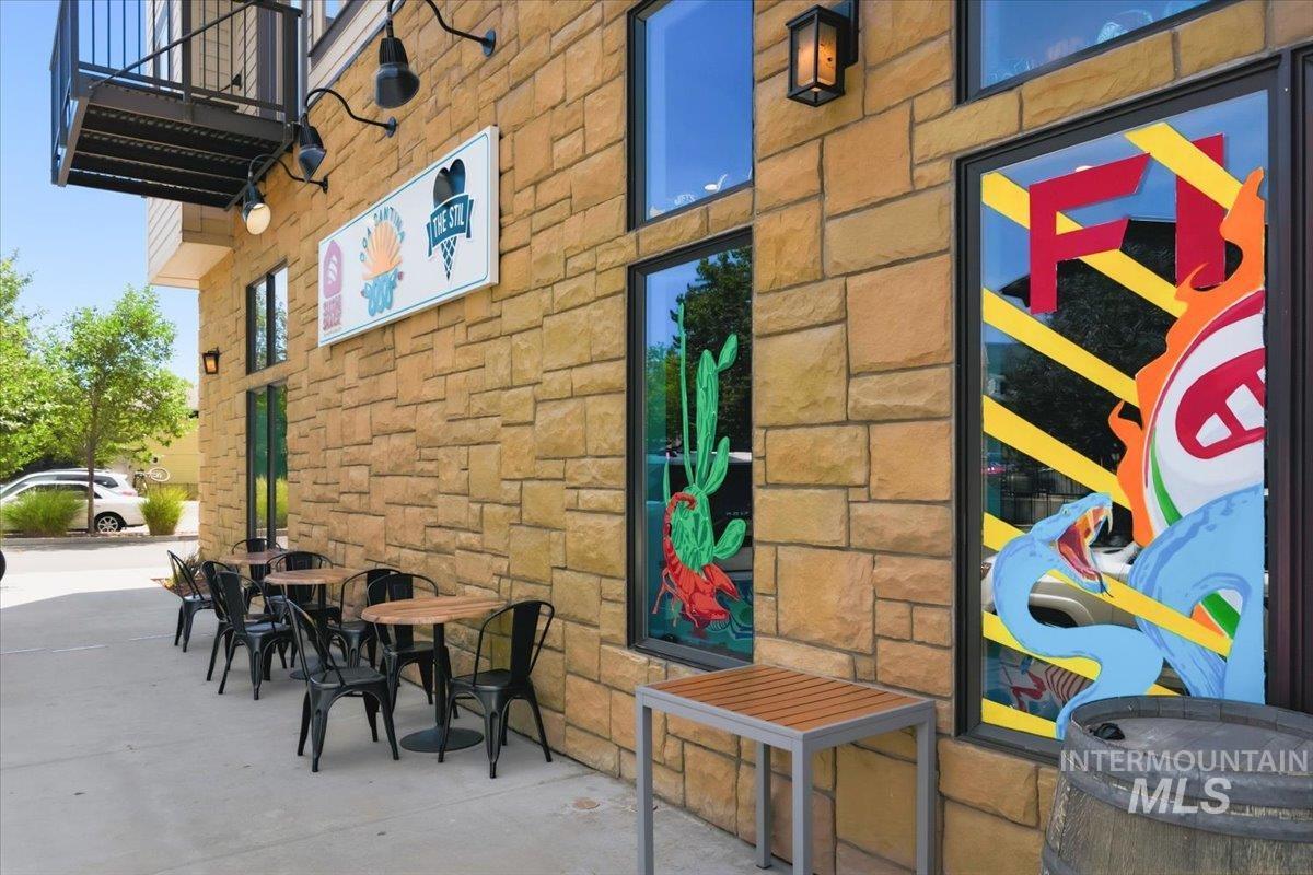 3794 South Single Tree Avenue Boise, ID 83716 - Photo 45 of 50 Stone facade building featuring multiple large windows and an exterior metal staircase