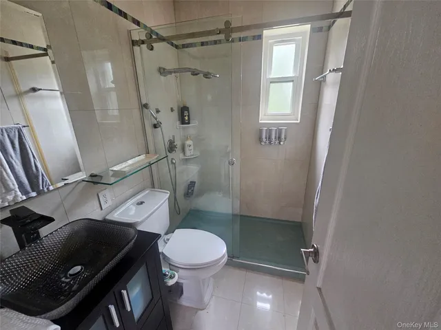 a bathroom with a toilet a sink and shower