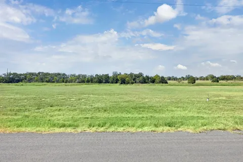 a view of a swimming pool and an outdoor seating