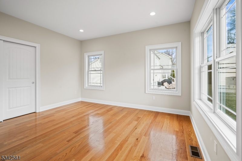 118 Cambridge Road Westfield, NJ 07090 - Photo 16 of 50 an empty room with wooden floor and windows