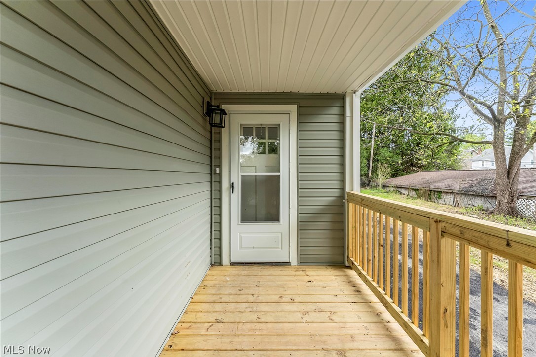 18155 Libby Road Maple Heights, OH 44137 - Photo 3 of 32 Covered porch featuring natural wood decking and railing