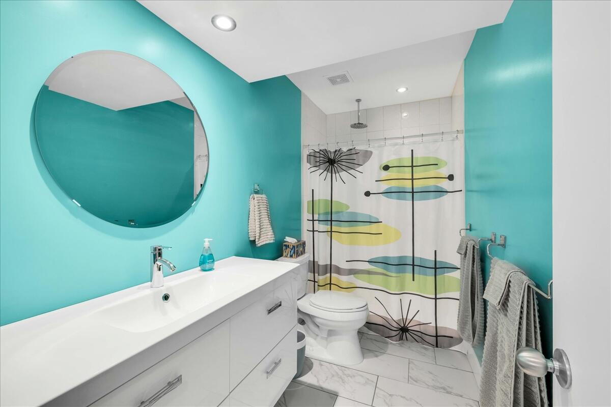 1050 Ramon Road, Unit 110 Palm Springs, CA 92264 - Photo 8 of 28 a bathroom with a sink mirror and a bathtub
