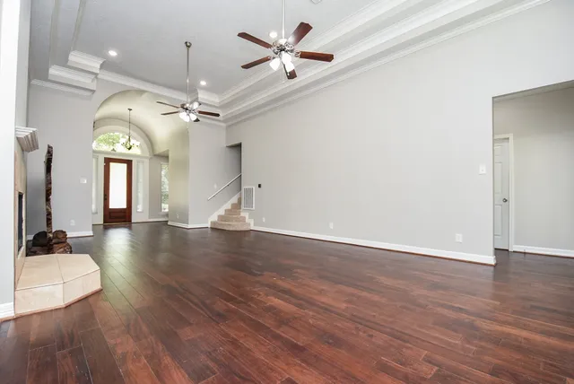 wooden floor in an empty room with a window