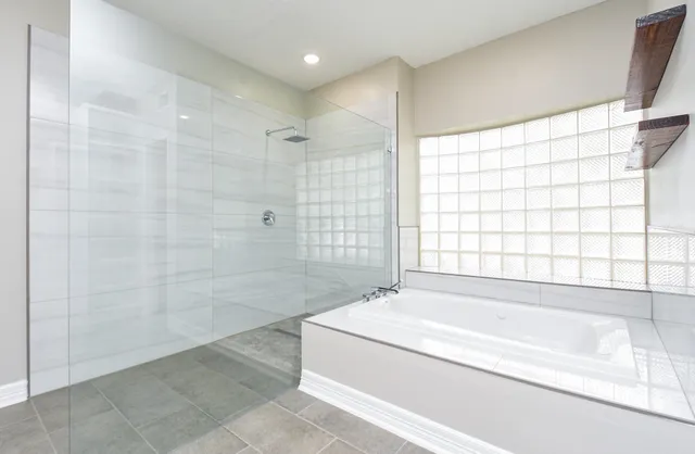 a bathroom with a bathtub and a shower