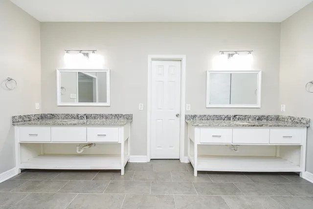 a bathroom with a tub sink and mirror