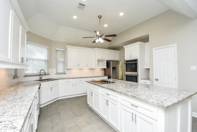 a kitchen with a stove sink and microwave