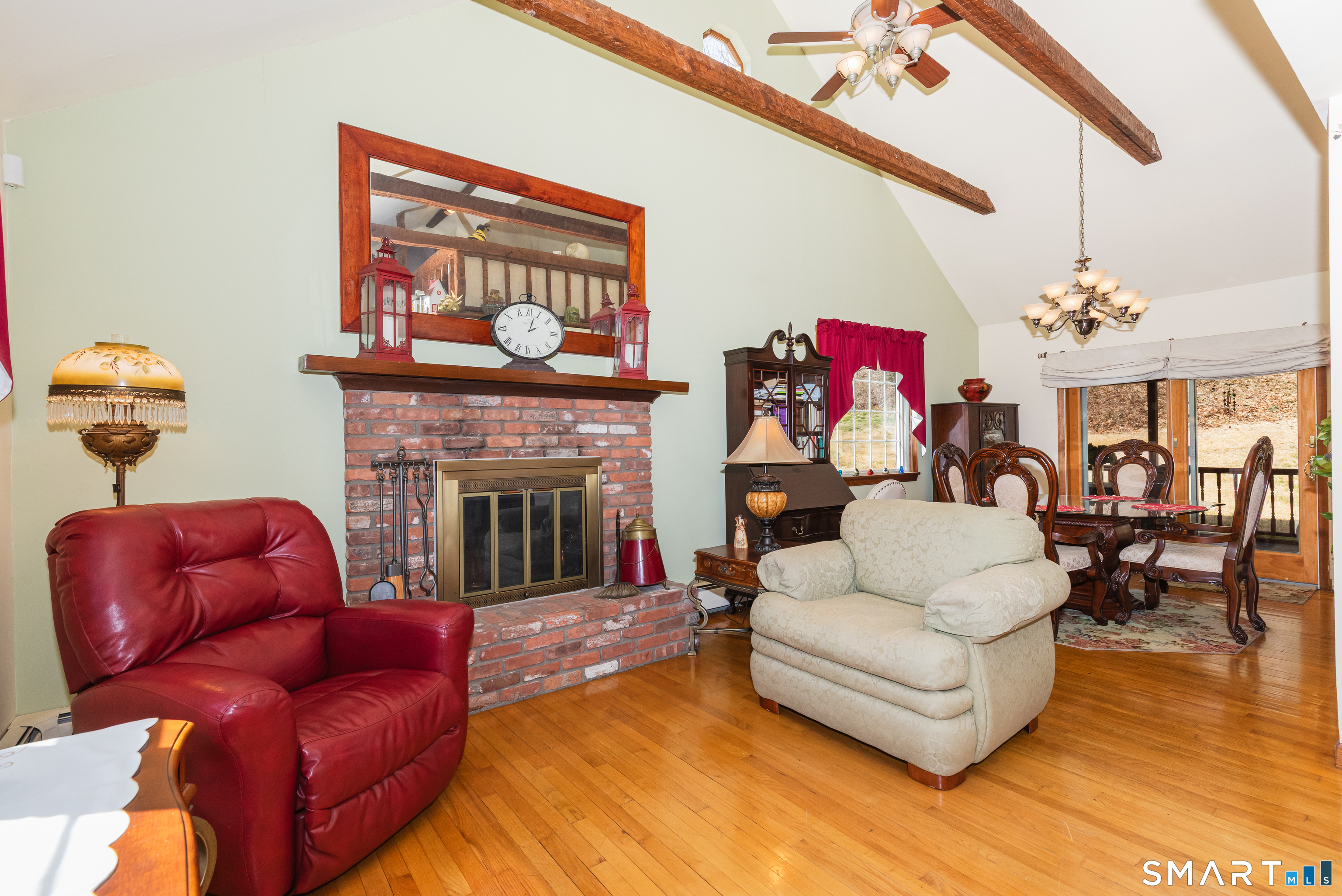 165 Community House Road Southbury, CT 06488 - Photo 11 of 29 a living room with furniture a fireplace and a chandelier