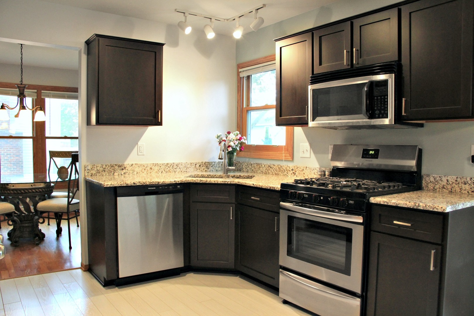 1316 Giese Road Batavia, IL 60510 - Photo 7 of 28 a kitchen with stainless steel appliances granite countertop a stove microwave and sink