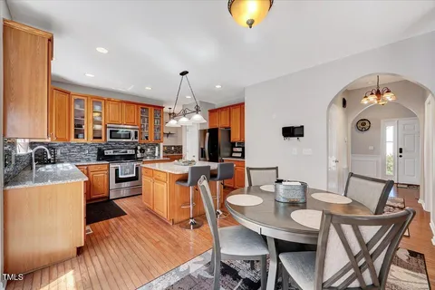 a dining room with furniture and wooden floor