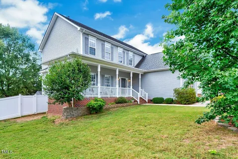 a front view of house with yard and green space