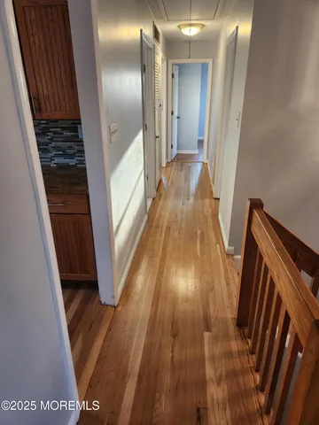 a view of a hallway and wooden floor