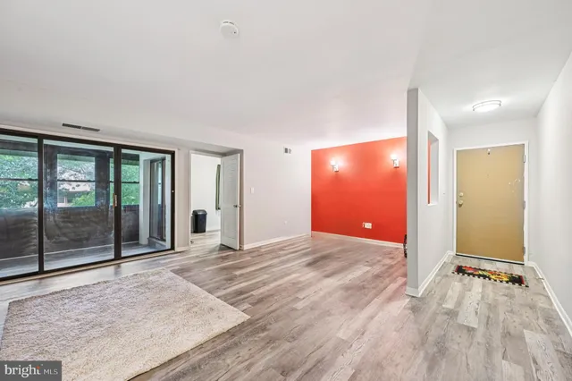 an empty room with window and doors