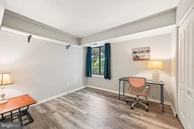 a view of a workspace with furniture and a window