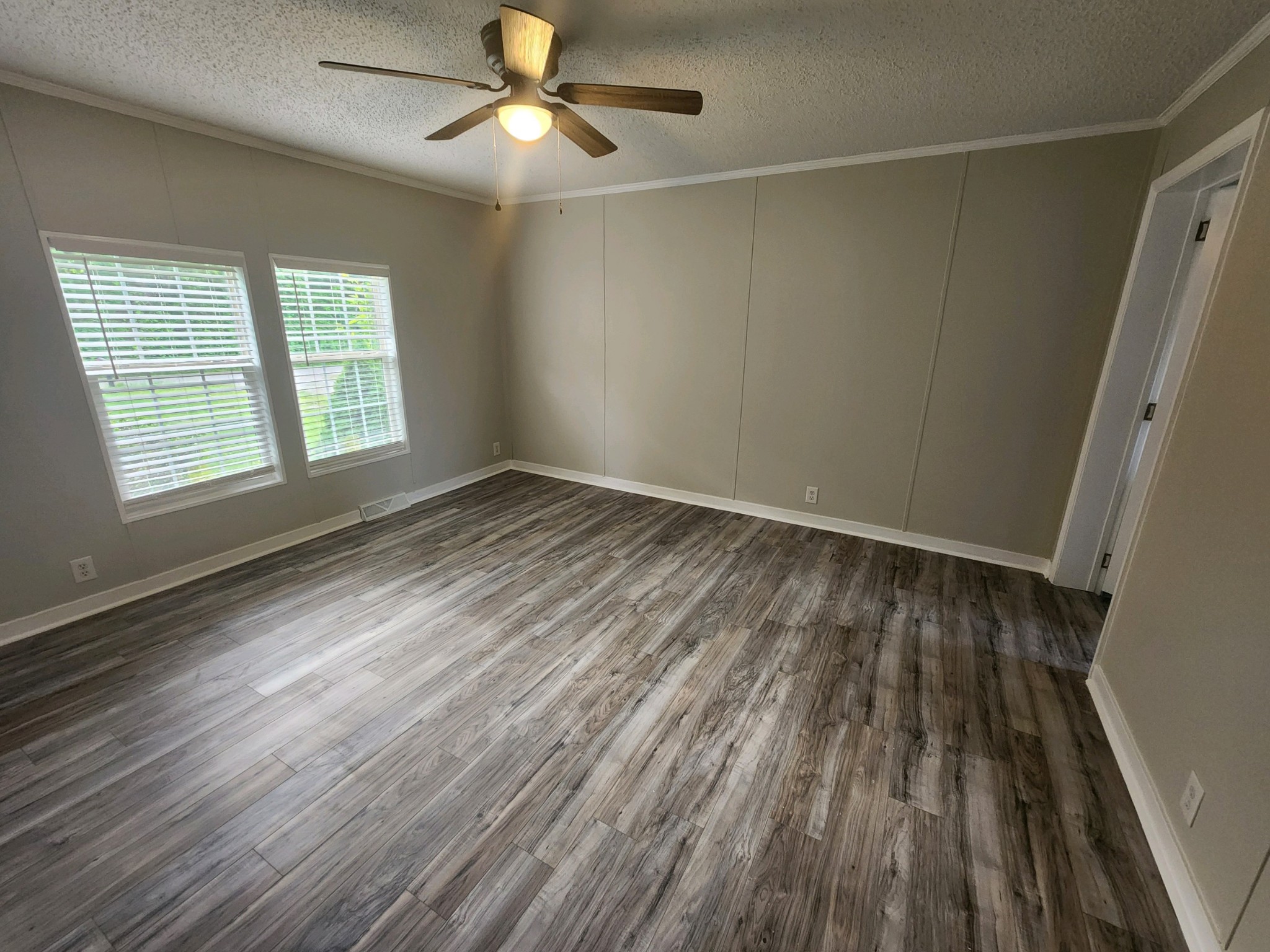 1056 Caney Branch Road Morrison, TN 37357 - Photo 5 of 12 an empty room with wooden floor fan and windows