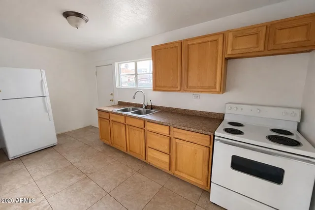 a kitchen with a sink cabinets and appliances