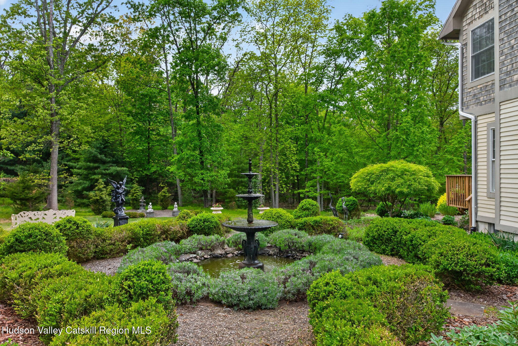 189 Bush Road Stone Ridge, NY 12484 - Photo 43 of 60 a view of a garden with plants and large trees