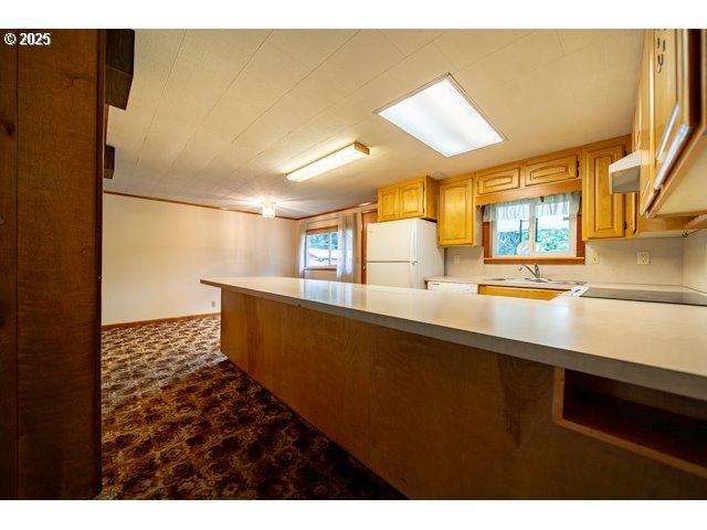 628 13th Street Lyons, OR 97358 - Photo 11 of 32 a kitchen with a sink and a refrigerator