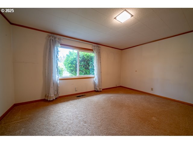 628 13th Street Lyons, OR 97358 - Photo 13 of 32 a view of empty room with wooden floor and fan