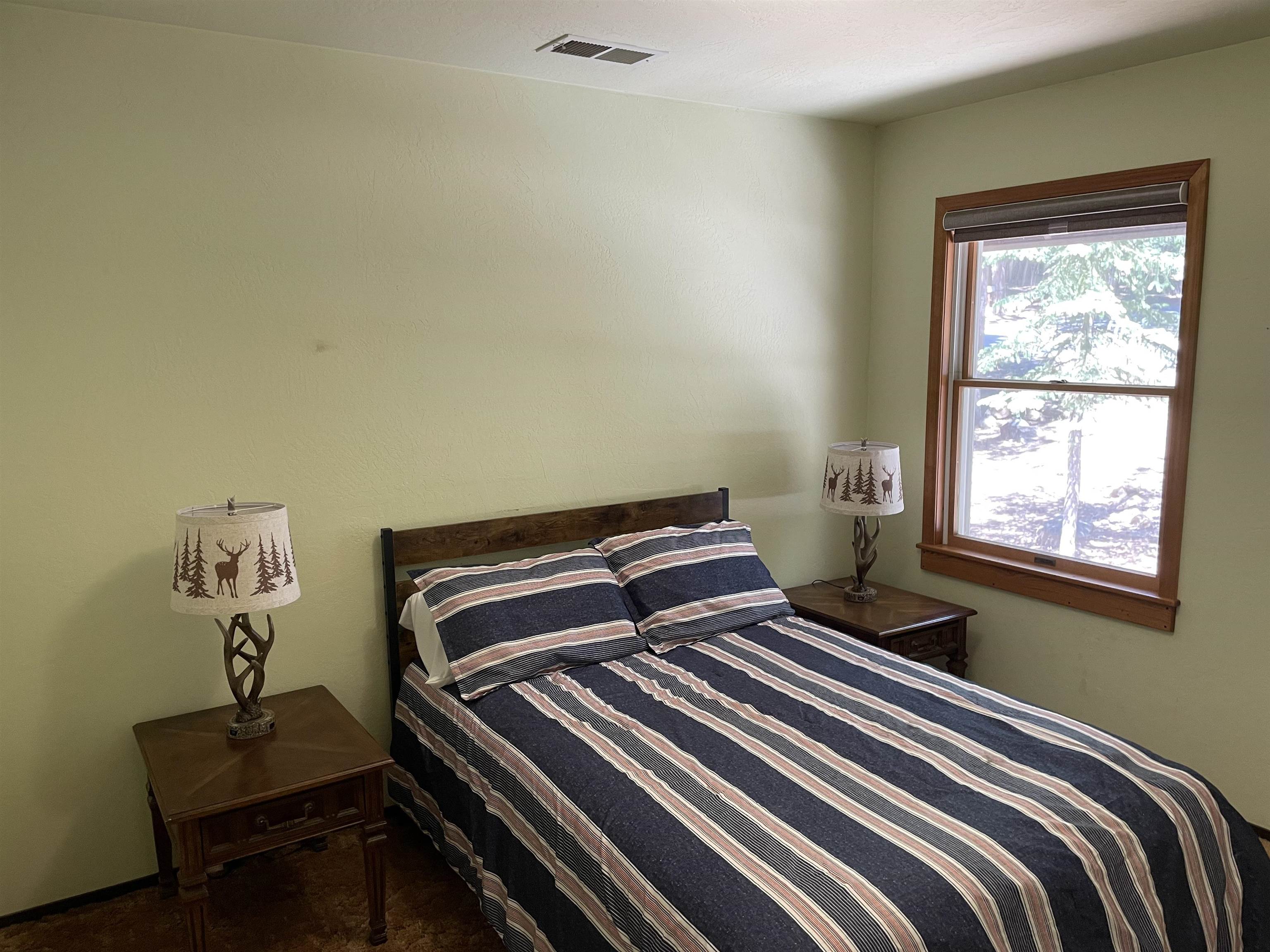 603 East Burnt Cedar Road Lake Almanor, CA 96137 - Photo 21 of 33 a bedroom with a bed and wooden floor