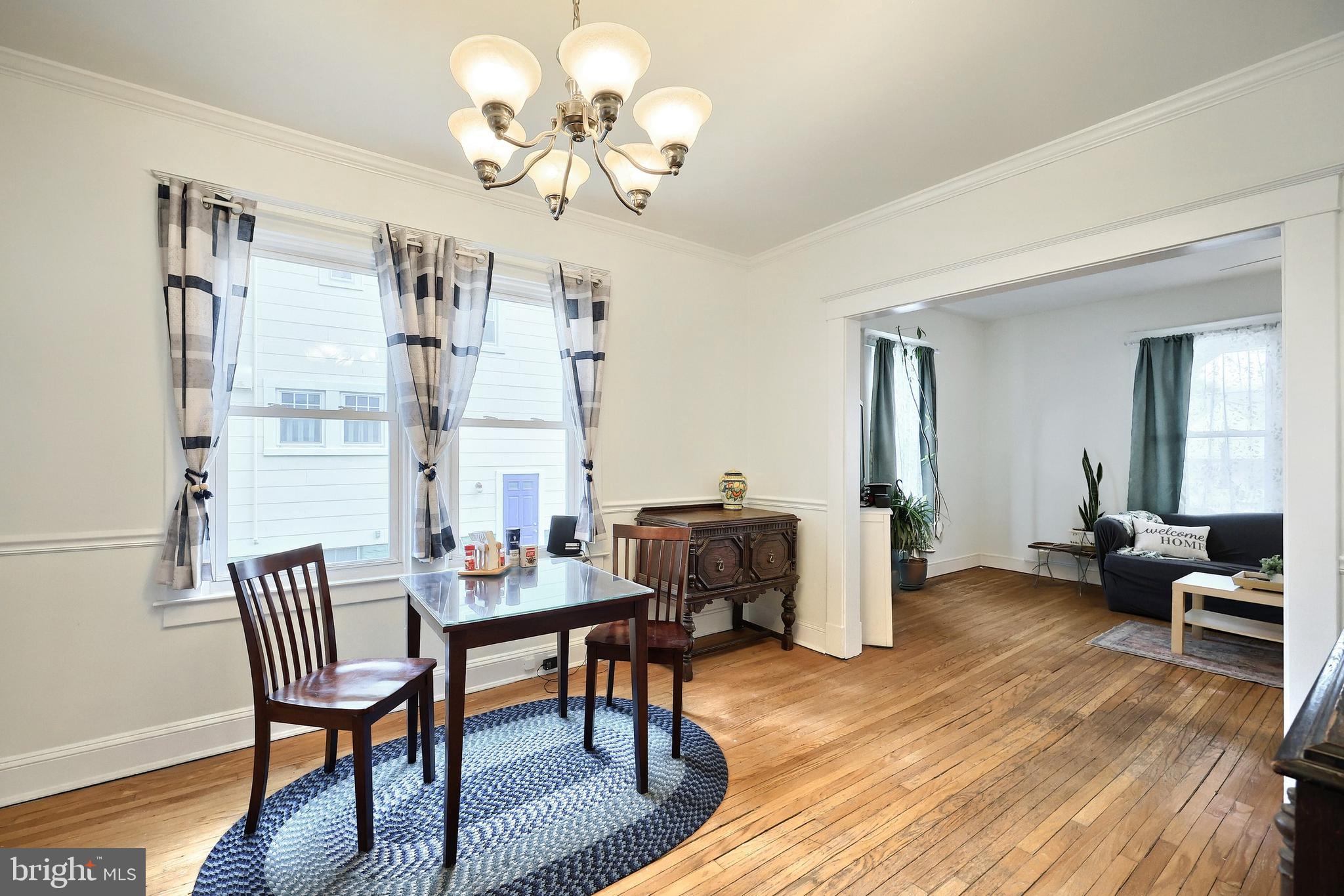 615 Dunkirk Road Baltimore, MD 21212 - Photo 12 of 45 a dining room with furniture a chandelier and wooden floor