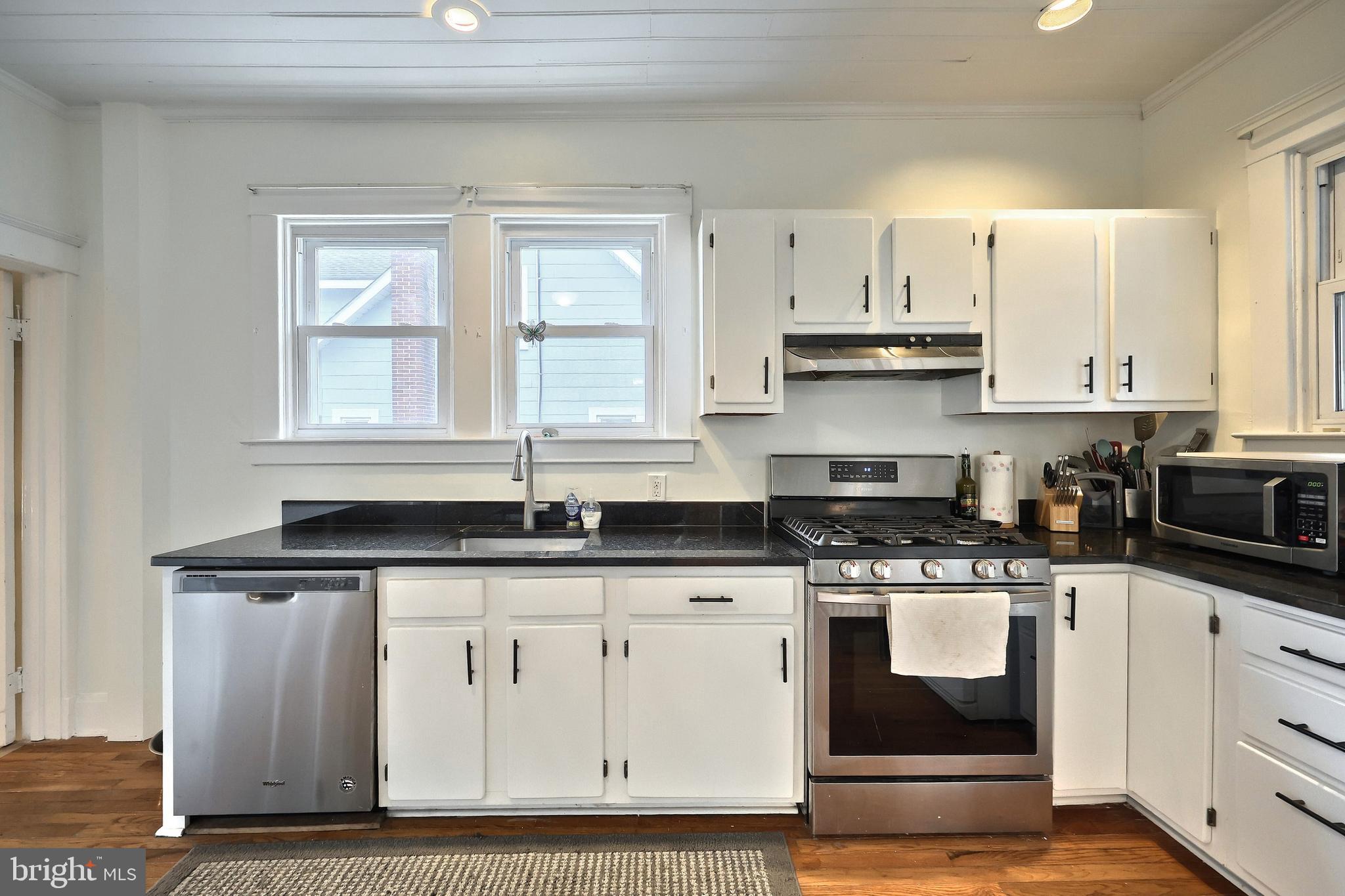 615 Dunkirk Road Baltimore, MD 21212 - Photo 14 of 45 a kitchen with granite countertop a sink and cabinets