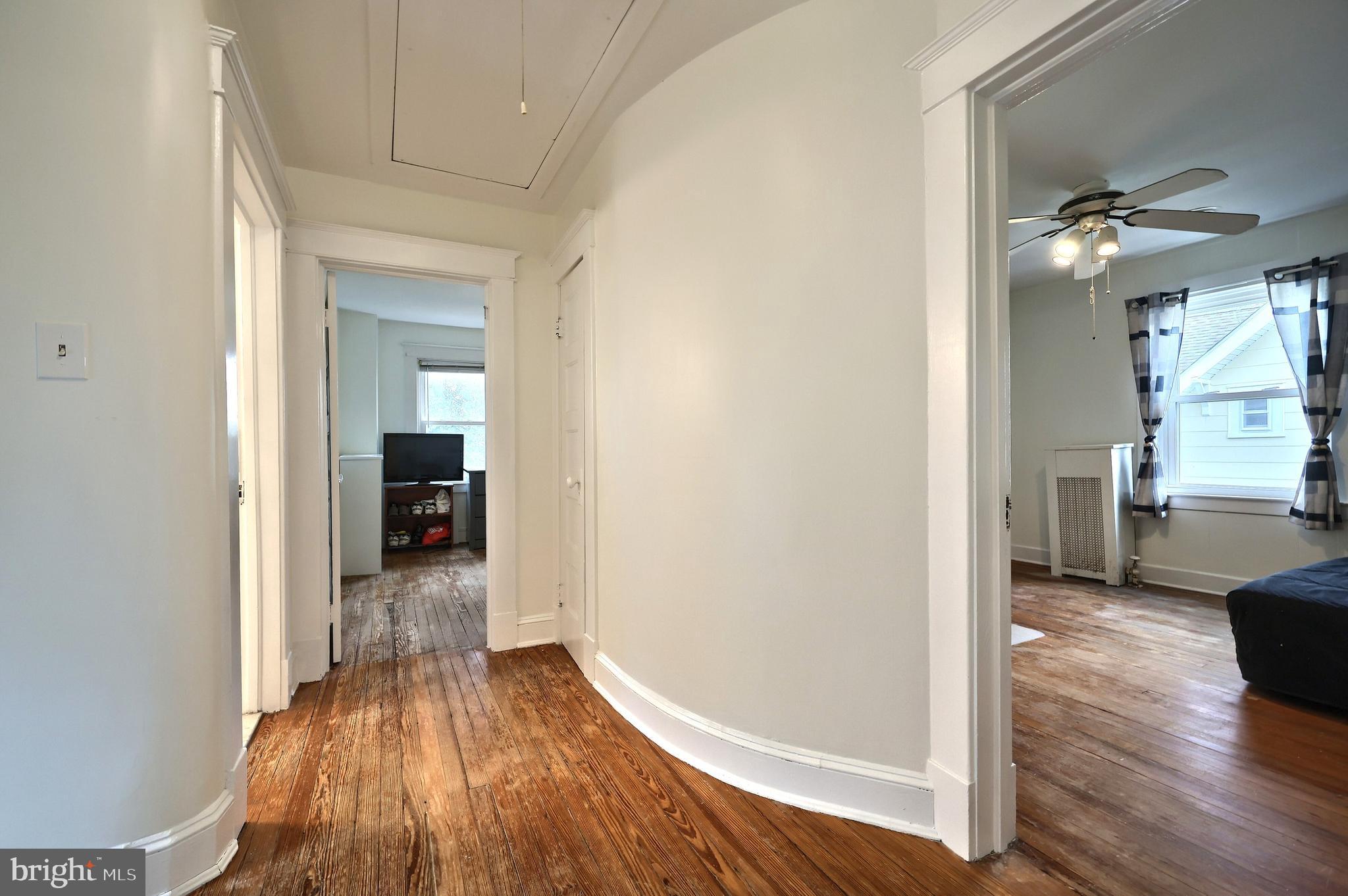 615 Dunkirk Road Baltimore, MD 21212 - Photo 18 of 45 a view of a room with wooden floor staircase and a living room