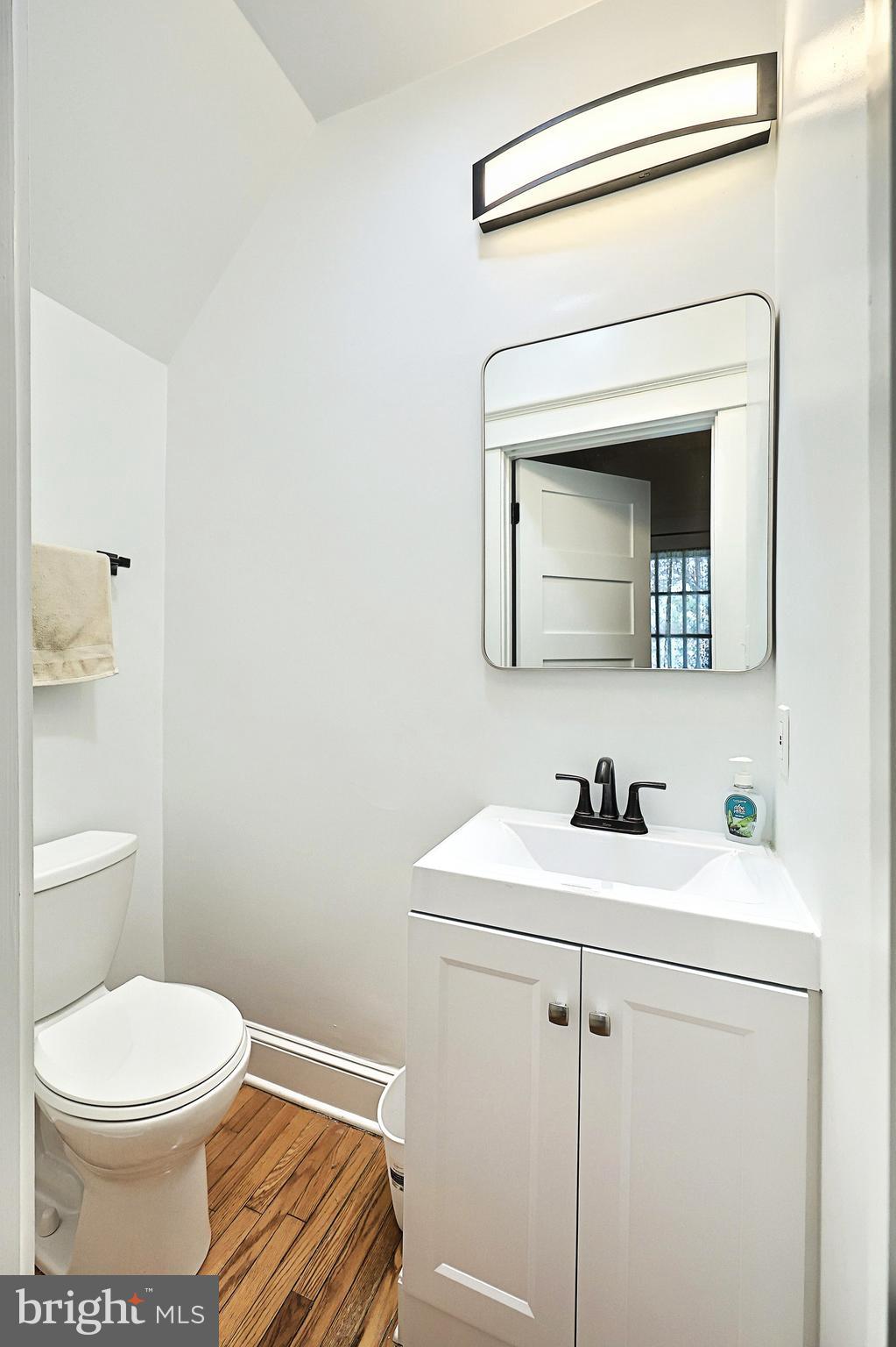 615 Dunkirk Road Baltimore, MD 21212 - Photo 26 of 45 a bathroom with a toilet sink and mirror